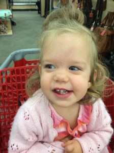 Katherine riding in a shopping cart.