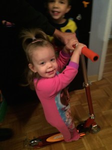 Katherine riding the scooter that J got for Christmas.