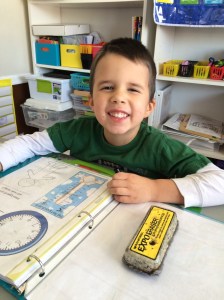 Jonathan working on her daily notebook for school.