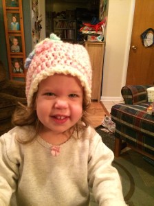Katherine wearing a hat that Grandma Joanne made for her.